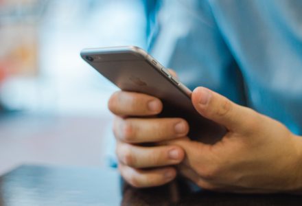 Closeup photo of a nurse practitioner using a smartphone