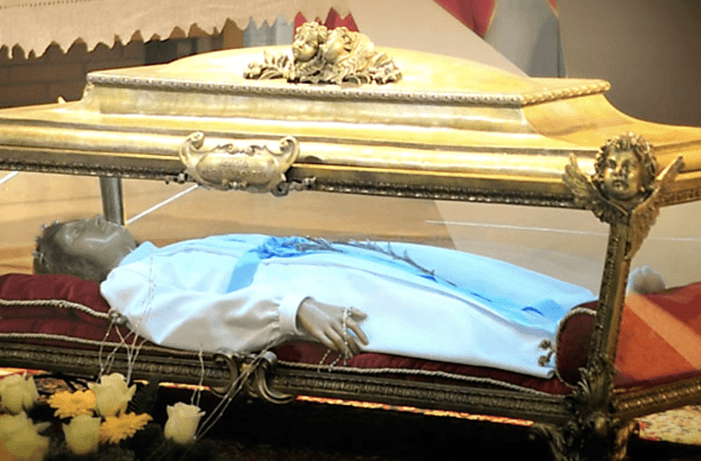 The wax-covered body of Maria Goretti in a glass reliquary
